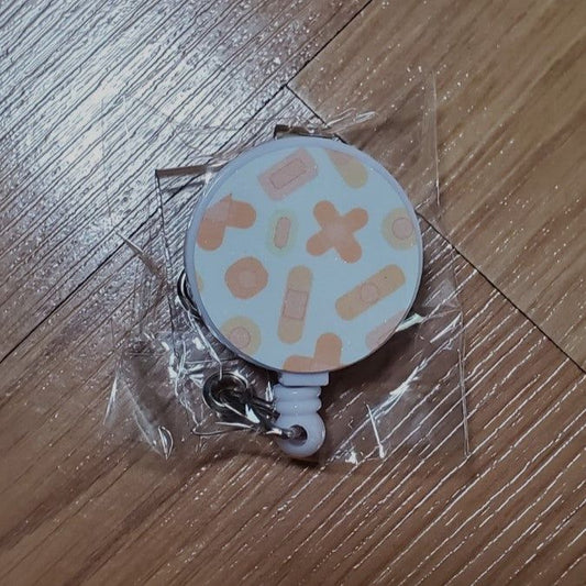 Badge reel, Bandaids design